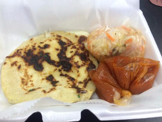 Fresh cheese pupusa served with curtido slaw and salsa roja
